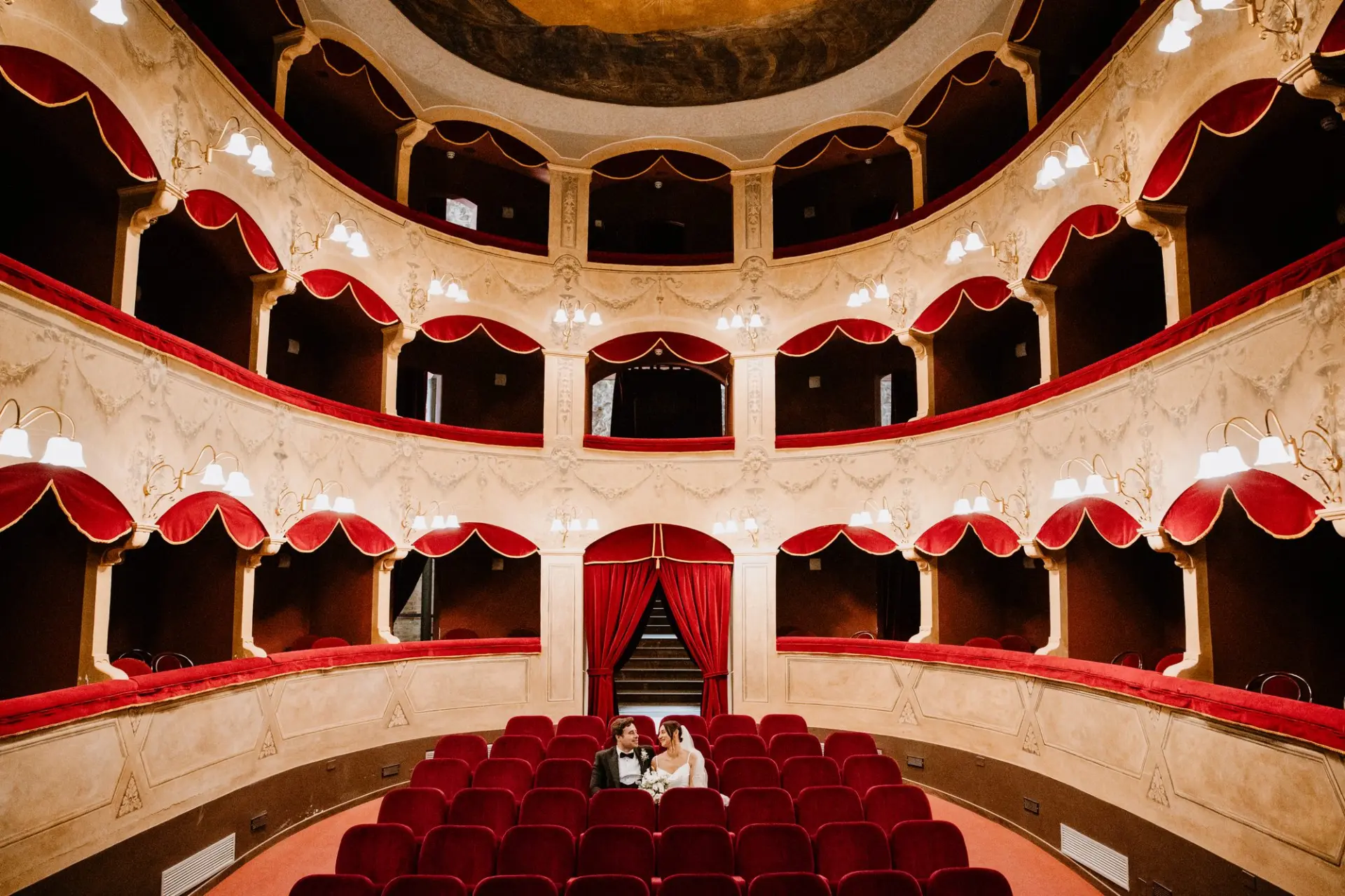 Bride and Groom in Historic Opera House Wide view of Teatro Salvatore Cicero in Cefalù with the newlyweds in the stalls
